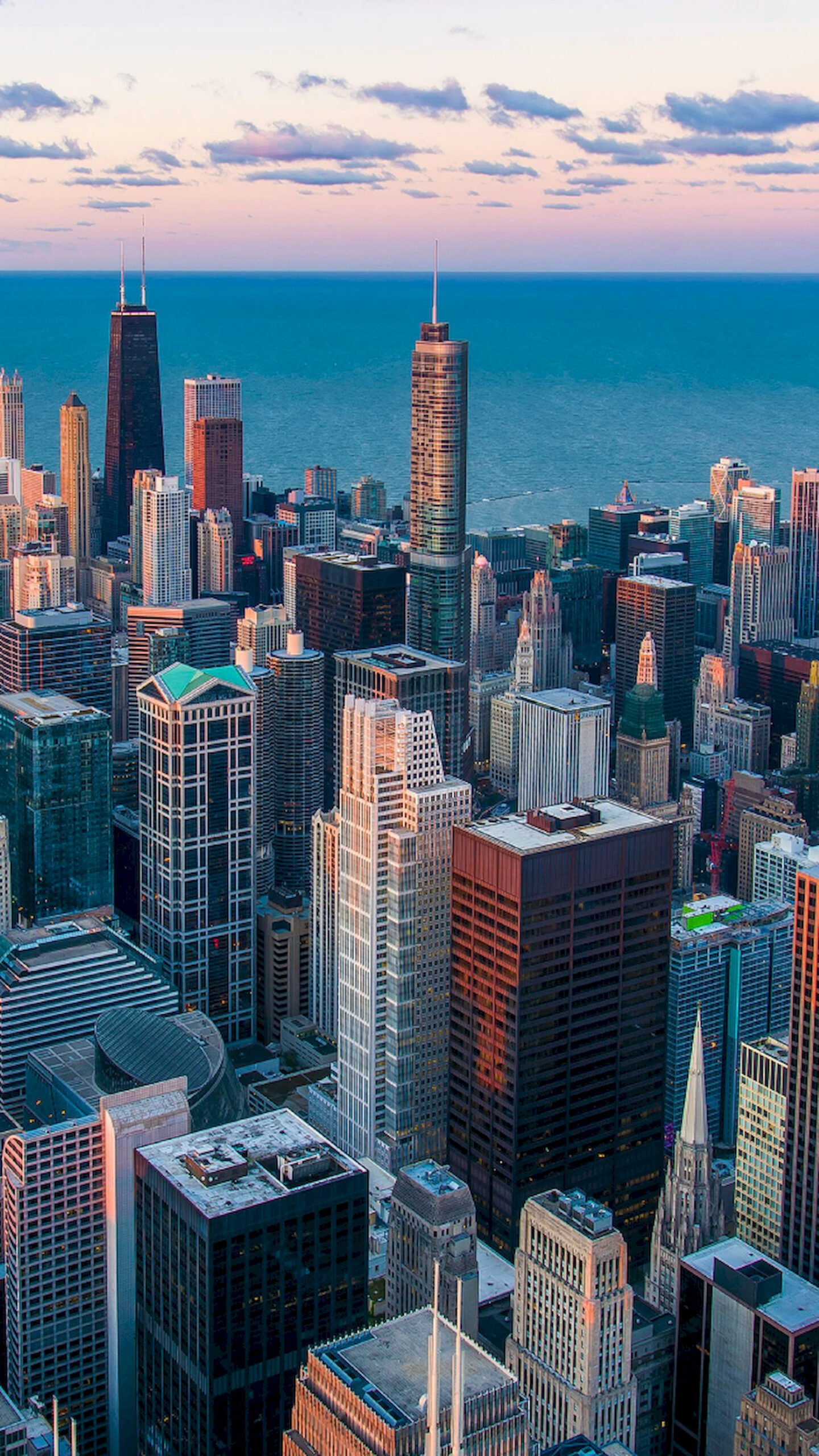 "Aerial view of Chicago skyline at sunset featuring the John Hancock Center and Lake Michigan, vertical 4K phone wallpaper."