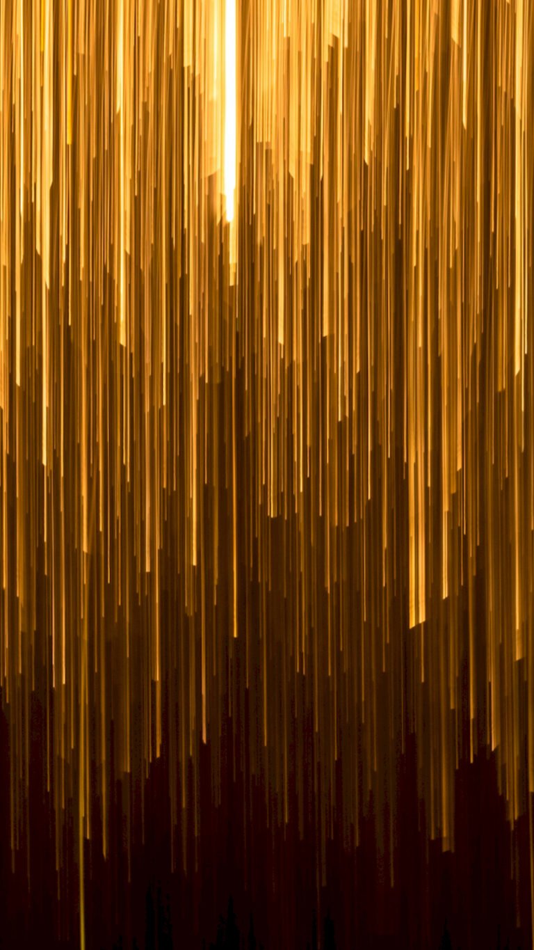 Abstract wallpaper featuring vertical streaks of bright golden light falling like rain against a dark brown and black background.