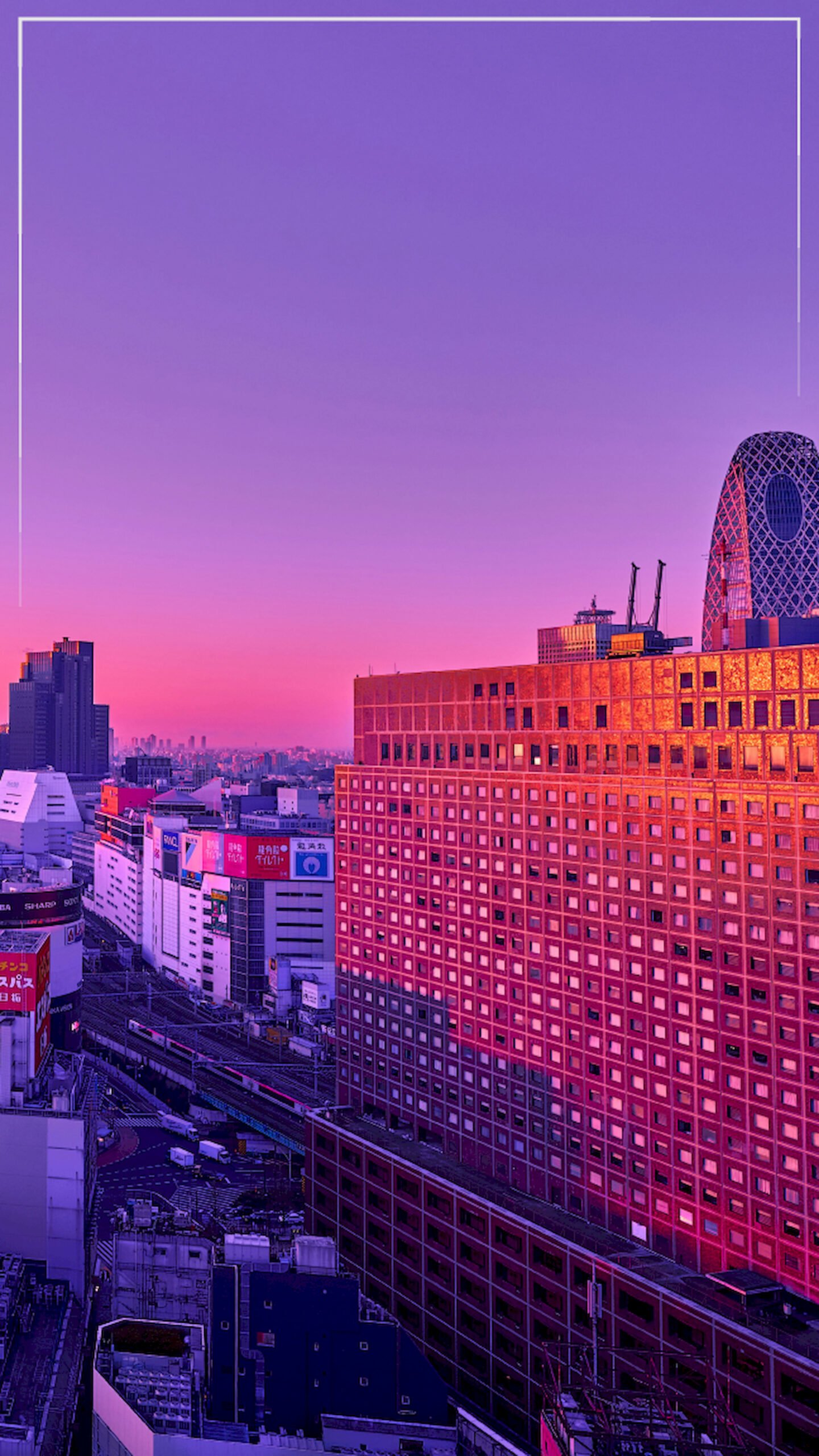 Vertical view of Shinjuku Tokyo skyline with Mode Gakuen Cocoon Tower under a pink and purple sunset, 4K phone wallpaper.